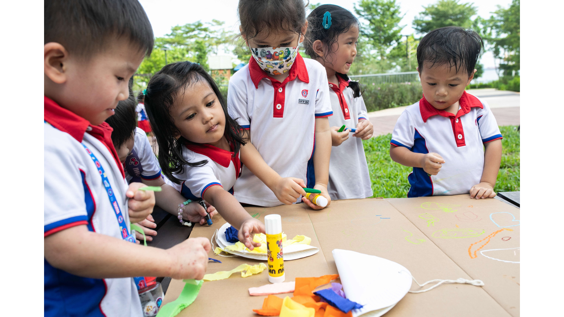 young children engaged in a arts and craft session with paper plates